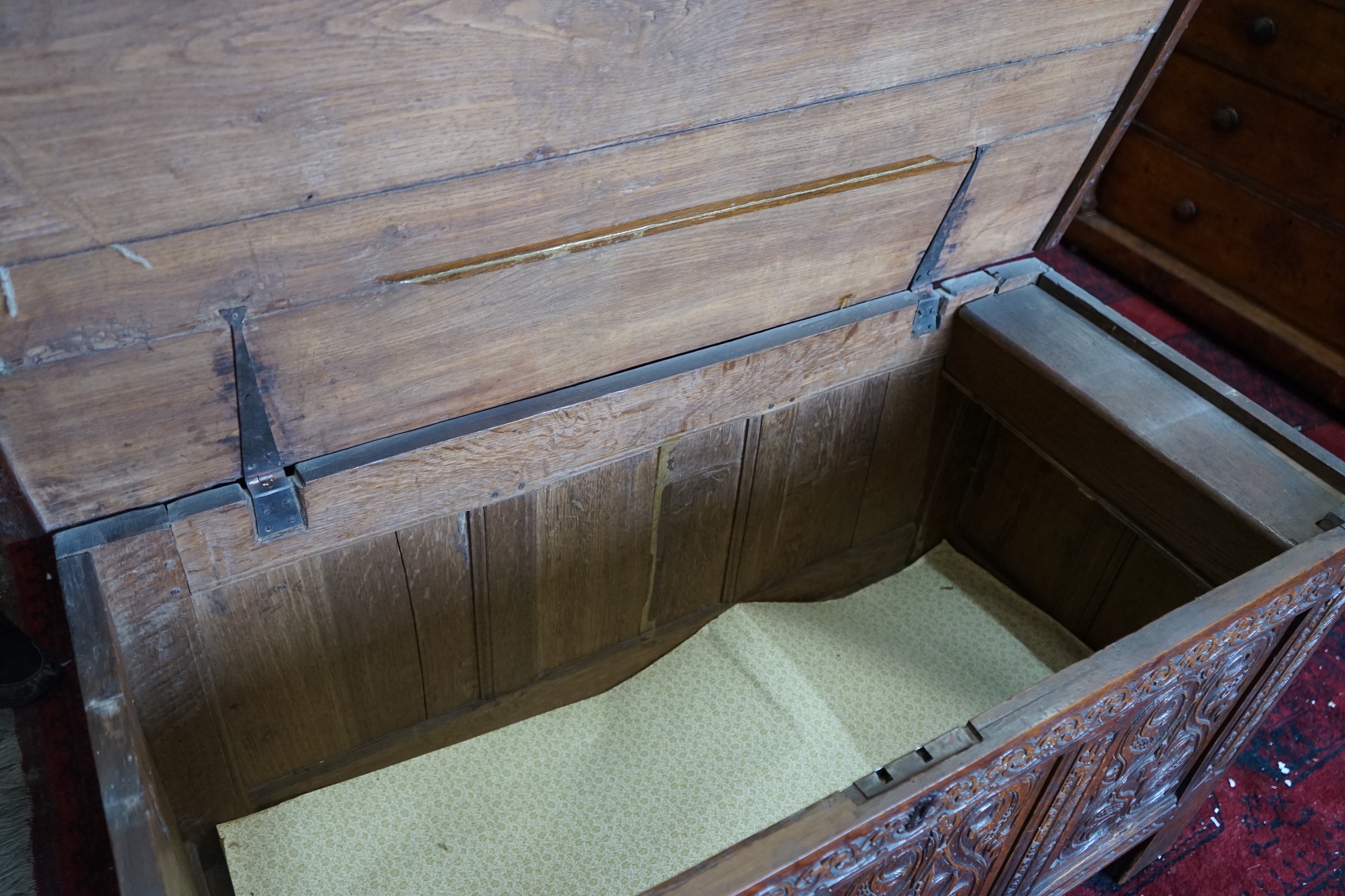 A late 17th /early 18th century carved oak panelled coffer, length 128cm, depth 58cm, height 72cm